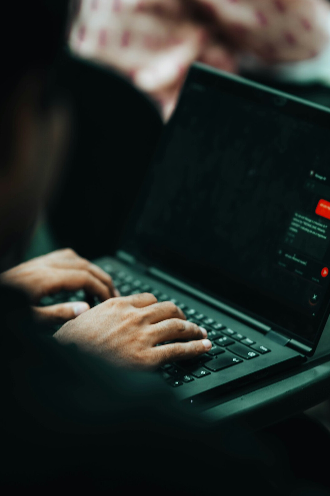 person coding on laptop